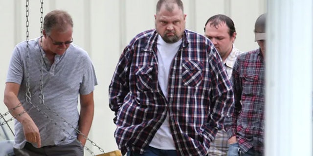 George "Billy" Wagner, center, and his sons George Wagner IV, in back, and Edward "Jake" Wagner, at right, attended the funeral of Gary Rhoden, 38, in Greenup, Ky.