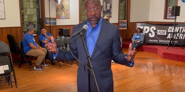 Democratic Georgia Sen. Raphael Warnock answers questions from the media following an event celebrating Hispanic Heritage Month at a church in Atlanta, Georgia on October 12, 2022.