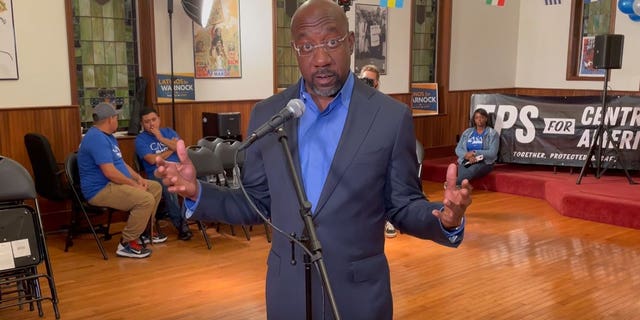 Democratic Georgia Sen. Raphael Warnock answers questions from the media following an event celebrating Hispanic Heritage Month at a church in Atlanta, Georgia on October 12, 2022.