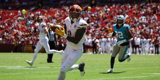Brian Robinson #8 of the Washington Commanders catches a pass against the Carolina Panthers during the first half of the preseason game at FedExField on August 13, 2022 in Landover, Maryland.