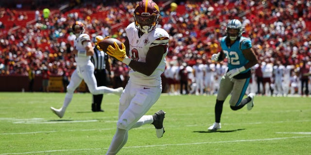 Brian Robinson #8 of the Washington Commanders catches a pass against the Carolina Panthers during the first half of a preseason game at FedExField on August 13, 2022 in Landover, Maryland.