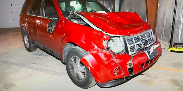 Extensive front-end damage shown on the red Ford Escape SUV Waukesha Christmas parade suspect Darrell Brooks allegedly used to mow down celebrants last year. The bumper appears to have been reattached with elastic cords at some point between the attack and when it was moved to the courthouse.