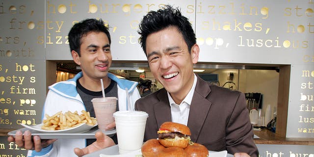 Actors Kal Penn and John Cho pose for a portrait while promoting their movie "Harold and Kumar Go To White Castle" at Pop's Burger in downtown New York City on July 19, 2004.