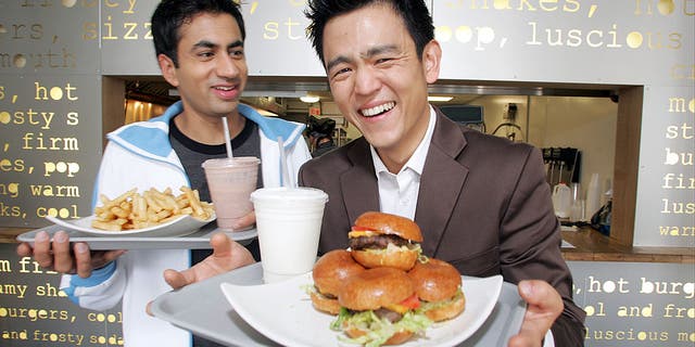 Actors Kal Penn and John Cho pose for a portrait while promoting their movie "Harold and Kumar Go To White Castle" at Pop's Burger in downtown New York City on July 19, 2004.