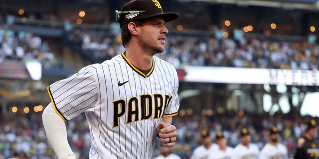 Wil Myers of the San Diego Padres runs onto the field during player introductions prior to the National League Championship Series against the Philadelphia Phillies at PETCO Park Oct. 18, 2022, in San Diego.