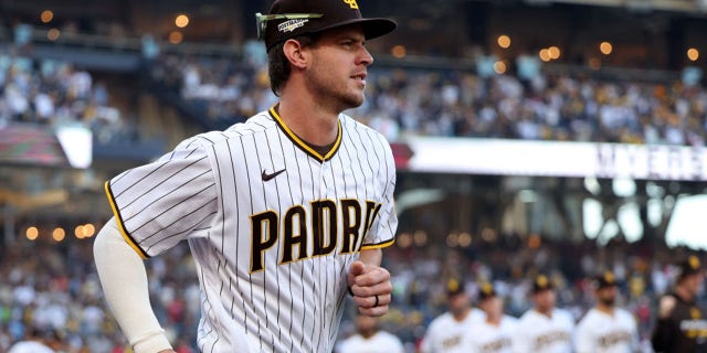 Wil Myers of the San Diego Padres runs down the court during player introductions ahead of the National League Championship Series against the Philadelphia Phillies at PETCO Park on October 18, 2022 in San Diego.