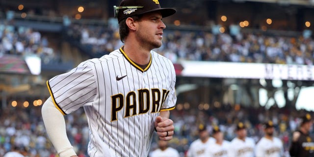 Wil Myers of the San Diego Padres runs onto the field during player introductions prior to the National League Championship Series against the Philadelphia Phillies at PETCO Park Oct. 18, 2022, in San Diego.