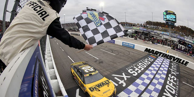 Christopher Bell, driver of the No. 20 DeWalt Toyota, takes the checkered flag to win the Xfinity 500 at Martinsville Speedway on Oct. 30, 2022, in Martinsville, Virginia.