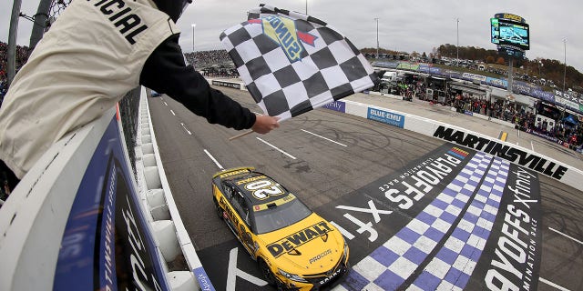 Christopher Bell, driver of the No. 20 DeWalt Toyota, takes the checkered flag to win the Xfinity 500 at Martinsville Speedway on Oct. 30, 2022, in Martinsville, Virginia.