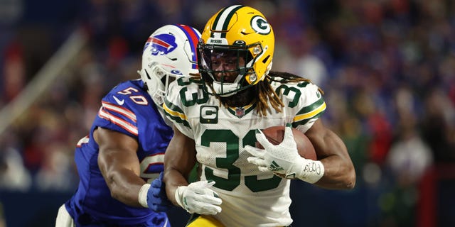 Aaron Jones #33 of the Green Bay Packers rushes during the third quarter against the Buffalo Bills at Highmark Stadium on October 30, 2022 in Orchard Park, New York.