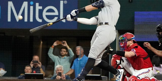 Judge hits his 62nd home run of the season during the first inning of the second game of a doubleheader against the Texas Rangers on Tuesday.