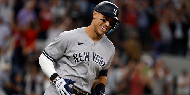 Aaron Judge #99 of the New York Yankees rounds the bases after hitting his 62nd home run of the season against the Texas Rangers during the first inning in game two of a double header at Globe Life Field on October 4, 2022, in Arlington, Texas. Judge has now set the American League record for home runs in a single season.