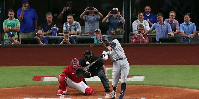 Aaron Judge of the New York Yankees hitting his 62nd home run of the season against the Texas Rangers in Arlington. Judge has now set the American League record for home runs in a single season. 