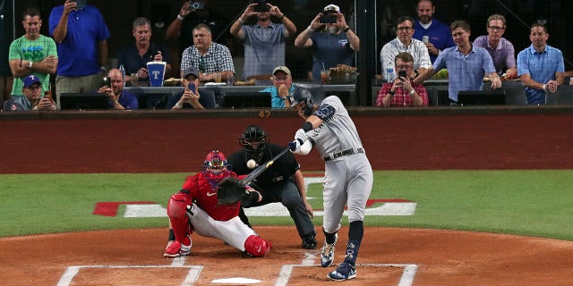 Aaron Judge #99 of the New York Yankees hits his 62nd home run of the season against the Texas Rangers during the first inning in game two of a double header at Globe Life Field on October 4, 2022 in Arlington, Texas. Judge has now set the American League record for home runs in a single season.