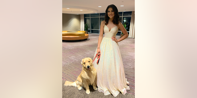 Alison Appleby and her service dog, Brady, are pictured at the Miss Dallas Teen pageant on Oct. 9, 2022.