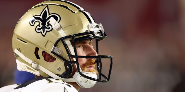 Quarterback Andy Dalton #14 of the New Orleans Saints watches from the sidelines during the 2nd quarter of the game against the Arizona Cardinals at State Farm Stadium on October 20, 2022, in Glendale, Arizona.