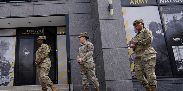 FILE - The U.S. Army National Guard members stand outside the Army National Guard office during training on April 21, 2022, in Washington. 