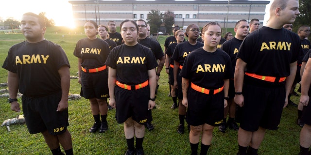 Soldiers outdoors in black Army PT uniforms