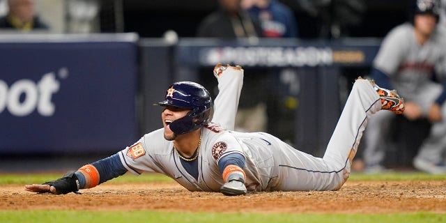 Houston Astros' Yuli Goriel reacts as he slides home safely to score against the New York Yankees during the sixth inning of Game Three of the Major League Baseball series, on Saturday, Oct. 22, 2022, in New York.