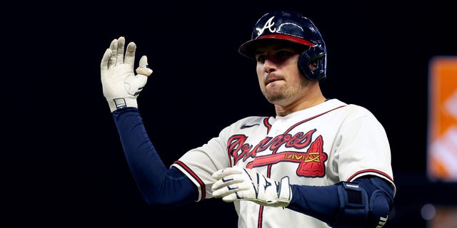 Austin Riley #27 of the Atlanta Braves reacts after a RBI single against the Philadelphia Phillies during the sixth inning in game two of the National League Division Series at Truist Park on October 12, 2022 in Atlanta, Georgia.