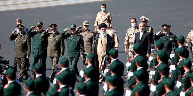 In this picture released by the official website of the office of the Iranian supreme leader, Supreme Leader Ayatollah Ali Khamenei, center, reviews a group of armed forces cadets during their graduation ceremony accompanied by commanders of the armed forces, at the police academy in Tehran, Iran, Monday, Oct. 3, 2022. 