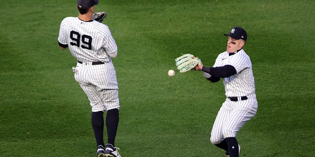 Harrison Bader #22 of the New York Yankees is unable to make the play on a fly ball in the second inning during Game 3 of the ALCS at Yankee Stadium on Saturday, Oct. 22, 2022, in New York, New York.