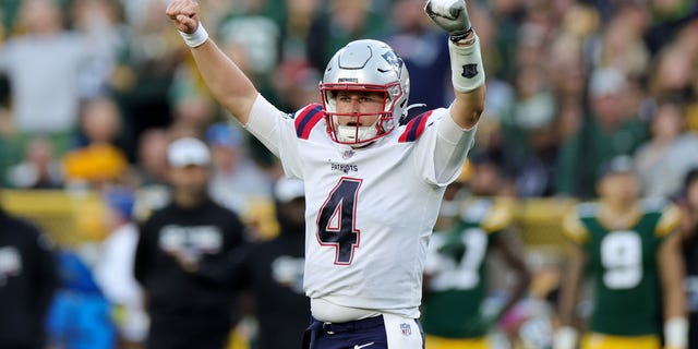Bailey Zappe of the New England Patriots reacts to a touchdown during the fourth quarter against the Green Bay Packers at Lambeau Field on Oct. 2, 2022, in Green Bay, Wisconsin.