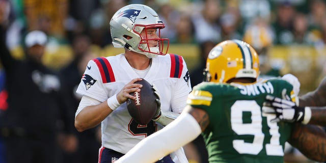 Bailey Zappe of the New England Patriots attempts a pass during the second quarter against the Green Bay Packers at Lambeau Field on Oct. 2, 2022, in Green Bay, Wisconsin.