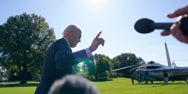 President Biden walks past reporters before boarding Marine One on the South Lawn of the White House on Thursday, October 20, 2022, in Washington.