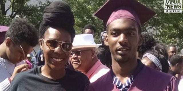 Mays stands with her son, Darnell "Booka" Woodard II at his high school graduation. He was killed in 2019 at 21 years old.