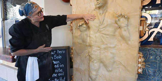 Catherine Pervan, co-owner of Our House Bakery in Benicia, California, shows off her life-size statue of Han Solo on Oct. 13, 2022.