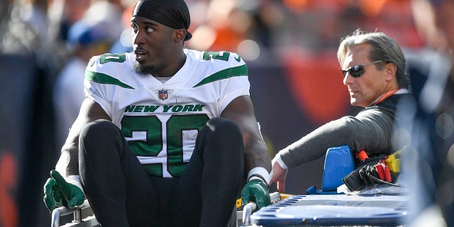 Breece Hall #20 of the New York Jets is carted off the field after an apparent injury following a play against the Denver Broncos during the first half at Empower Field At Mile High on October 23, 2022, in Denver, Colorado.
