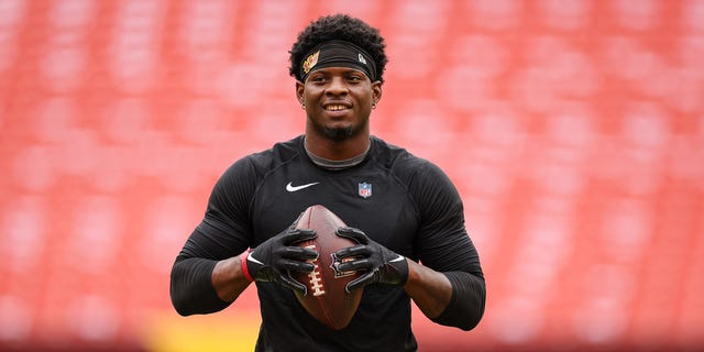 Brian Robinson #8 of the Washington Commanders warms up before the game against the Philadelphia Eagles at FedExField on Sept. 25, 2022 in Landover, Maryland. Robinson was shot twice in the leg during an attempted robbery on Aug. 28, 2022.