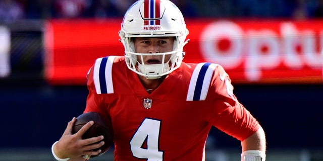 Bailey Zappe of the New England Patriots scrambles against the Detroit Lions at Gillette Stadium on Oct. 9, 2022, in Foxborough, Massachusetts.