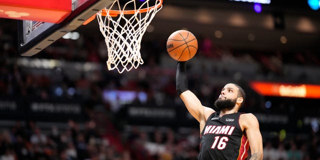 Caleb Martin #16 of the Miami Heat scores on a break away dunk against the Philadelphia 76ers in the second half at FTX Arena on March 05, 2022 in Miami, Florida.