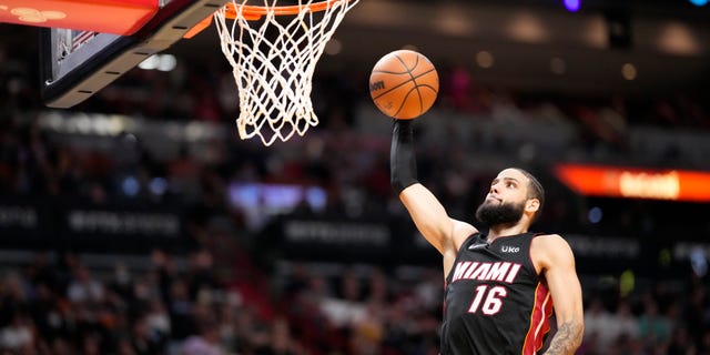 Caleb Martin #16 of the Miami Heat scores on a break away dunk against the Philadelphia 76ers in the second half at FTX Arena on March 05, 2022 in Miami, Florida.