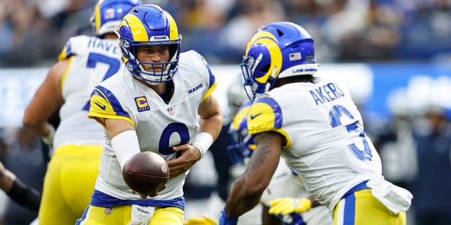 Matthew Stafford (9) of the Los Angeles Rams hands off to Cam Akers during the game against the Dallas Cowboys at SoFi Stadium on Oct. 9, 2022, in Inglewood, California.