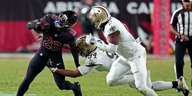 Arizona Cardinals running back Eno Benjamin (26) carries against New Orleans Saints defensive end Cameron Jordan (94) during the second half of an NFL football game, Thursday, Oct. 20, 2022, in Glendale, Ariz. (AP Photo/Ross D. Franklin)