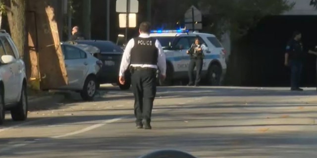 Officers are pictured while investigating a shooting on the Southwest Side on Saturday. Chicago police said there were at least 32 shooting incidents and 35 shooting victims over the weekend.