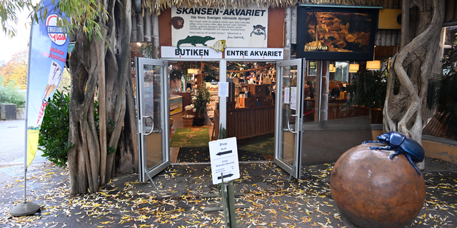 The Skansen Aquarium's entrance, part of the zoo on Djurgarden island, where a deadly snake escaped on Saturday via a light fixture in the ceiling of its glass enclosure, in Stockholm, Sweden, Monday Oct. 24, 2022.