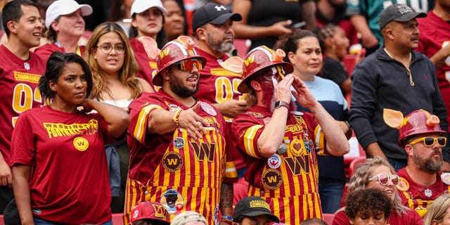 Washington Commanders fans react during the game between the Washington Commanders and the Philadelphia Eagles at FedEx Field on September 25, 2022 in Landover, Maryland.