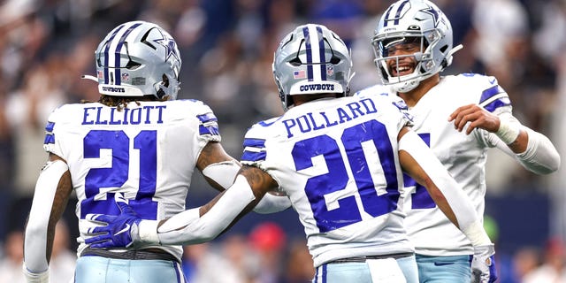 Dak Prescott, #4 of the Dallas Cowboys, celebrates with Ezekiel Elliott, #21, and Tony Pollard, #20, after a touchdown against the Detroit Lions during the fourth quarter at AT&T Stadium on Oct. 23, 2022 in Arlington, Texas.