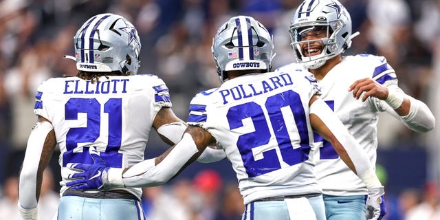 Dak Prescott, #4 of the Dallas Cowboys, celebrates with Ezekiel Elliott, #21, and Tony Pollard, #20, after a touchdown against the Detroit Lions during the fourth quarter at AT&T Stadium on Oct. 23, 2022 in Arlington, Texas.