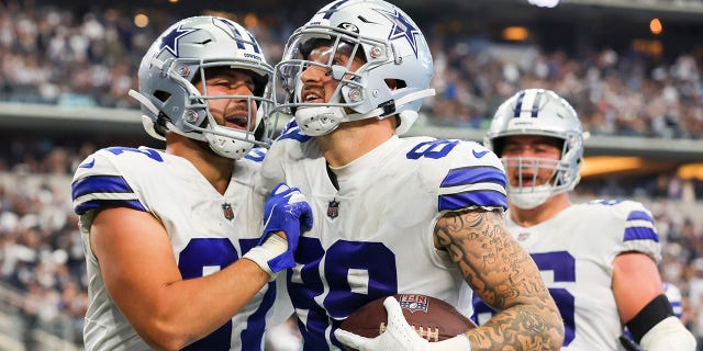 Peyton Hendershot #89 of the Dallas Cowboys is congratulated by Jake Ferguson #87 (L) after scoring a touchdown against the Detroit Lions during the fourth quarter at AT&T Stadium on October 23, 2022 in Arlington, Texas.Â