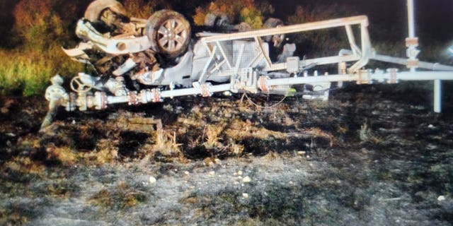 The truck came to a stop upside down off the roadway.