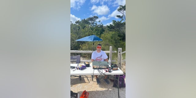 Dale Klonin sits outside with his ham radio gear. Ham radio operators everywhere "do so much behind the scenes, and they never get any credit," he said.