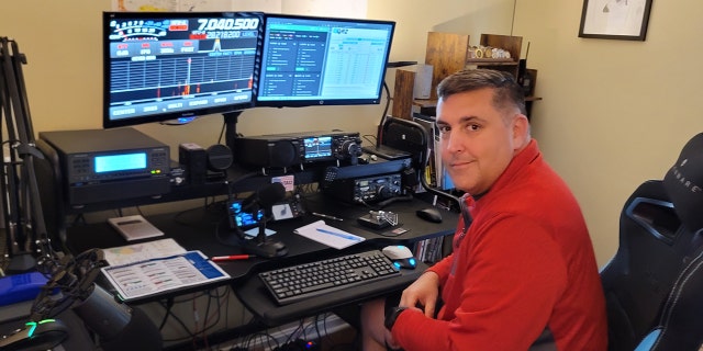 Dale Klonin is shown at his ham radio set-up. Klonin was able to lead rescuers to 10 people and a dog who were all stranded on Sanibel Island, Florida, during Hurricane Ian.