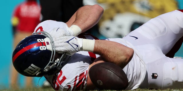 Daniel Bellinger #82 of the New York Giants is injured on the play in the first half against the Jacksonville Jaguars at TIAA Bank Field on Oct. 23, 2022 in Jacksonville, Florida.