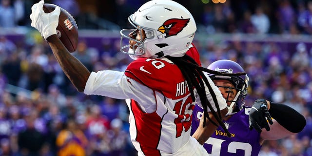 DeAndre Hopkins of the Arizona Cardinals takes the ball for a touchdown against the Minnesota Vikings at US Bank Stadium on October 18 30, 2022, in Minneapolis.