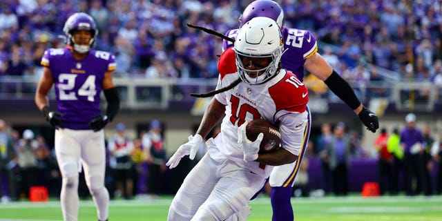 DeAndre Hopkins of the Arizona Cardinals takes the ball for a touchdown against the Minnesota Vikings at US Bank Stadium on October 18 30, 2022, in Minneapolis.